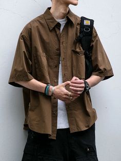 Casual urban style featuring a relaxed brown short-sleeve shirt, layered over a white tee. Paired with black cargo pants, accessorized with a black backpack, silver bracelets, rings, and a digital watch. This look embodies a modern, functional aesthetic perfect for everyday wear.   #UrbanFashion #StreetStyle #CasualOutfit #MenStyle #FunctionalFashion #Layering #MinimalistFashion #Menswear #ModernLook Summer Wear Men Street Styles, Men’s Hippie Fashion, Japanese Street Style Men, Mens Streetwear Summer, Amsterdam Fits, Japanese Fashion Men, Jordan Clothes, Japanese Streetwear Mens, Cargo Coat