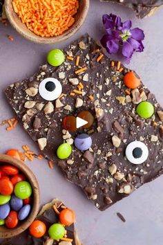 halloween treats are arranged on a table with candy eyes and candies in small bowls