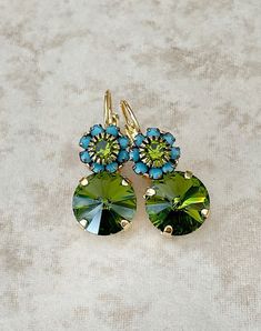 Pretty pair of earrings featuring 12mm round olive and 8mm round floral Swarovski crystals.  Gold metal finish.  Lever back earring closure for pierced ears.  1 1/2 inches long x 12mm wide at the widest part of the earring. Green Round Flower Earrings For Wedding, Green Flower Wedding Earrings, Green Flower Earrings With Ear Wire For Wedding, Green Flower Earrings For Wedding With Ear Wire, Nickel-free Green Round Flower Earrings, Blue Bridal Earrings, Something Blue Bridal, Jeweled Earrings, Blue Bridal