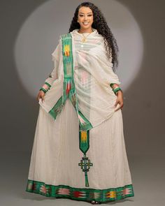 Celebrate the vibrant culture of Ethiopia with this modern Habesha dress in a captivating shade of emerald green. Traditional motifs are reimagined with a contemporary twist, creating a dress that is both stylish and steeped in cultural significance. Perfect for special occasions or as a statement piece, this dress is sure to turn heads. Material Cotton Thread Menen Estimated delivery : 2 weeks to 3 weeks Delivered to your door 14days return policyFree shipping! Contact WhatsApp +1(304)-306-2784Email: contact@ethiopian.store Modern Habesha Dress, Habesha Dress, Ethiopian Traditional Dress, Ethiopian Women, Ethiopian Dress, Habesha Kemis, Traditional Dress, Green Design, Unique Dresses