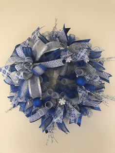 a blue and silver mesh wreath on a wall