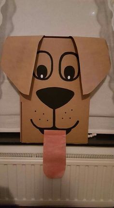 a cardboard dog head on top of a radiator