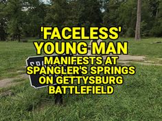 a sign that says faceless young man in front of a grassy field with trees