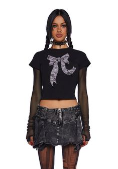 This graphic tee has a stretchy knit construction, short sleeves, and a textured lace bow graphic on the front with stud detailing. Y2k Crew Neck T-shirt For Night Out, Fitted Lace Top T-shirt With Crew Neck, Fitted Short Sleeve Lace Top T-shirt, Edgy Black T-shirt For Party, Edgy Stretch T-shirt For Night Out, Edgy Graphic Print T-shirt For Party, Edgy Party T-shirt With Graphic Print, Y2k T-shirt For Night Out In Spring, Graphic Tee For Fall Night Out