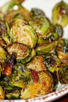 brussel sprouts on a white plate with brown speckles