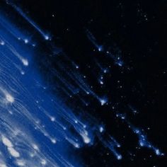 an airplane flying through the night sky with stars on it's back end and some clouds in the background