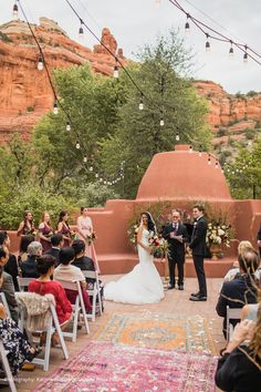 a bride and groom standing at the end of their wedding ceremony in sedona, arizona