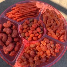 there are many different types of food in the bowl on this plate, including carrots and dog treats