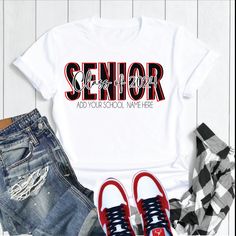 a white shirt with the words senior on it next to some shoes and plaid shirts