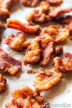 bacon pieces are sitting on a piece of parchment paper