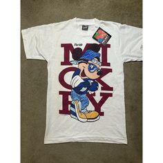 This Vintage T-Shirt From The 1990s Features A Graphic Print Of Mickey Mouse, Specifically His Florida Outfit, In Black Color. The Shirt Is Made Of Cotton Material And Has A Crew Neck And Short Sleeves. The Shirt Is Perfect For Anyone Who Loves Nature, Art, Usa, Hippie, Colorful, Dad, Cartoon, Birthday, California, City, Classic, Florida, Retro, Hipster, Beach, School, Holiday, Love, College, Outdoor, 80s, 90s, And Hip Hop. The Shirt Is A Regular Fit And Is Available In Size Small. The Shirt Is Florida Outfits, Disney Lover, Disney Shirts, Vintage Tshirts, Cotton Material, Graphic Prints, Florida, Tee Shirts, Short Sleeves