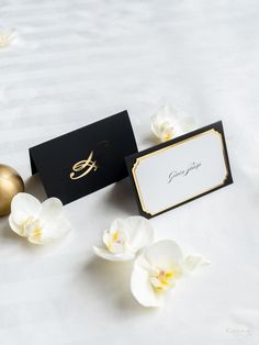 a table topped with white flowers and cards