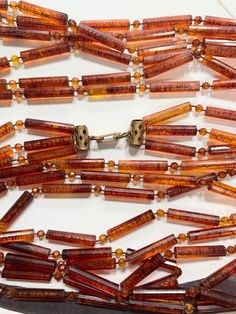 50 inch long from the 1920s 3 strand necklace of beautiful amber tone two type of beads - long and small - an incredible Etsy find - it's in great vintage condition - all the beads are in place - these photos don't do it justice - you can wear it long or double - I am not sure of the material - possibly an early lucite but it's light and comfortable to wear - thank you for coming to my store - I ship fast and wrap beautifully - please reach out if you have any questions Classy Earrings, Hippie Necklace, Necklace Statement, The 1920s, Multi Strand Necklace, Metal Style, Strand Necklace, Multi Strand, Gatsby