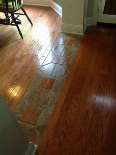 an empty living room with hard wood flooring and white trim on the door way