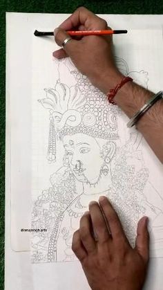 a man is drawing on paper with his hand