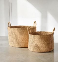 two woven baskets sitting on top of a table