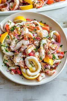 two white plates filled with shrimp and veggies