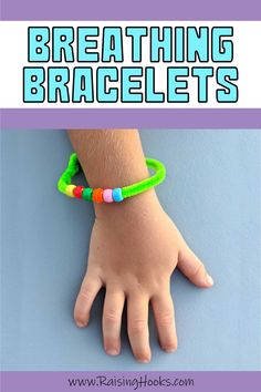 a child's hand wearing a bracelet with the words breathing bracelets on it