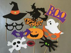 a group of halloween photo booth props on top of a table with the words trick or treat