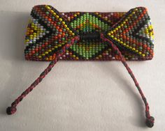 a small beaded purse on a white surface