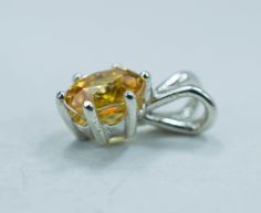 This is a beautiful natural and untreated Yellow Zircon from Madagascar set in Sterling Silver. This amazing stone has a great shade of golden/yellow that is very sought after and not easily found as well as a stunning cut which makes this Zircon really shine with an amazing luster and the best clarity! You will not be disappointed with this beautiful pendant! Zircon not to be confused with Cubic Zirconia is a natural gemstone and one of the oldest known materials on the planet! It also is one o Oval Yellow Sapphire Jewelry With Prong Setting, Round Yellow Sapphire Jewelry With Diamond Cut, Yellow Citrine Round Gemstones, Faceted Round Topaz Jewelry, Round Yellow Citrine Gemstones, Round Faceted Topaz Jewelry, Yellow Faceted Citrine Jewelry, Faceted Yellow Citrine Jewelry, Round Cut Yellow Sapphire Jewelry With Diamond Cut