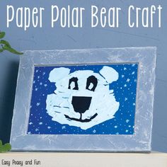 a paper polar bear craft is displayed on a shelf