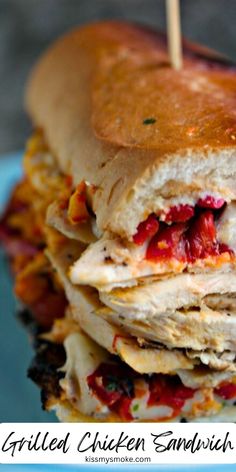 a stack of pancakes with meat and cheese on them, sitting on a blue plate