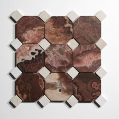 several different types of marble tiles on a white surface, arranged in the shape of hexagonals