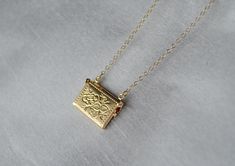 "This beautiful and personalized locket necklace would be a perfect Valentine's gift for any loved one! The gold plated letter locket charm measures approximately 21x16mm (including jump ring) and is hung on a 16\", 18\" or 20\" gold plated or 14k gold filled chain. The locket opens and you can add a tiny photo or sweet note inside. The chains are dainty and very pretty - the perfect delicate necklace for everyday wear. This sentimental gift is sure to be the recipient's favorite piece of jewelr Gold Personalized Locket Necklace Gift, Personalized Gold Locket Necklace For Anniversary, Personalized Gold Necklace With Vintage Charm, Gold Necklaces For Keepsake Gift, Personalized Gold Locket Necklace Gift, Dainty Engraved Locket Necklace As Gift, Personalized Gold Locket Necklace For Gift, Gold Locket Necklace With Engraving Option As A Gift, Dainty Gold Locket Necklace For Gifts