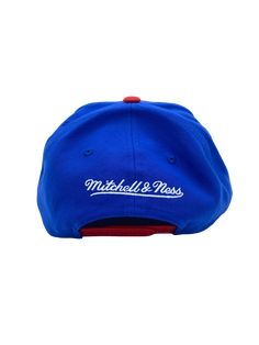 Clean and classic look with the Mitchell & Ness feel to it. You want to be sure everyone knows that you will always support your team. You can do just that by putting on this Classic 2 Tone snapback hat from Mitchell & Ness. It features bold graphics embroidered on the crown, perfect for showcasing your style. High Crown Structured fit Adjustable hat One size fits all Flat bill Snapback Six panels with eyelets Raised embroidery One size fits most Officially licensed Imported Brand: Mitchell & Ne Blue Baseball Cap For College During Baseball Season, Blue Snapback Baseball Cap For Game Day, Blue Casual Snapback Hat For Game Day, Collegiate Blue Hats For Streetwear, Blue Baseball Cap For Game Day, Blue College Snapback Hat, Blue Throwback Snapback Hat For Sports, Blue Flat Bill Snapback Hat For Game Day, Blue Snapback Baseball Cap For College