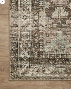 the area rug is made from wood and has an intricate design on it, with various colors