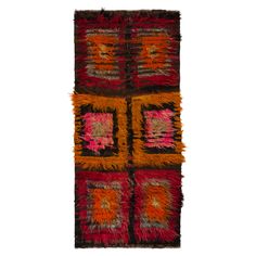 a multicolored rug with squares and fringes on the bottom, in different colors