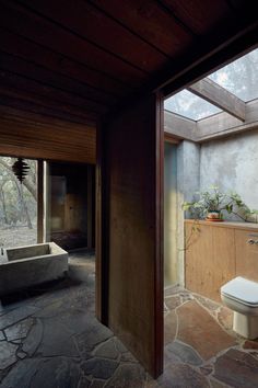 a bathroom with stone flooring and walls