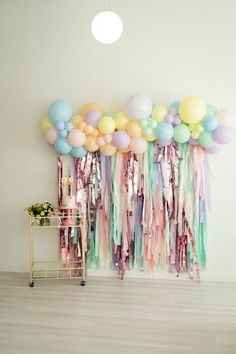 a room with balloons and streamers on the wall