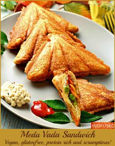 a plate with some food on it and a fork next to it, along with the words medak vada sandunch