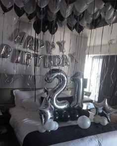 balloons are in the shape of numbers on a bed