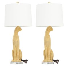 a pair of table lamps that have animals on them, one sitting down and the other standing up