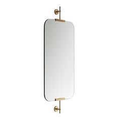 a large mirror hanging on the wall next to a faucet with two handles