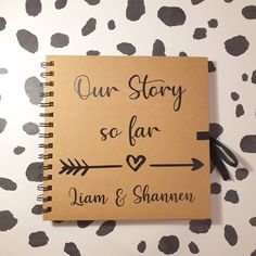 a notebook with the words our story so far written in cursive writing on it