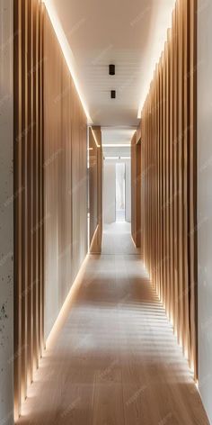 a long hallway with wooden slats on the walls and flooring along one side