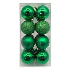 green christmas ornaments in a package on a white background