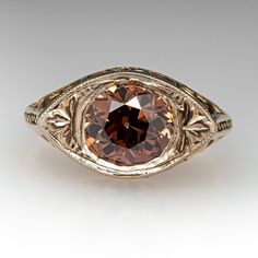 This elegant vintage ring is centered with one (1), bead set, old European cut diamond weighing 1.25 carats. The side faces of the ring feature a pierced design. The ring measures 8.7mm at the top, rises 5.5mm above the finger, tapering to 1.5mm wide and 1.1mm thick at the base of the shank. This ring is currently a size 3. Vintage Jewelry With Filigree And Round Cut, Vintage Jewelry With Filigree, Antique Round Cut Formal Jewelry, Antique Diamond Cut Jewelry, Vintage Formal Ring With Round Stone, Antique Round Band Jewelry For Formal Occasions, Vintage Jewelry With Prong Setting For Formal Events, Collectible Victorian Style Round Topaz Ring, Antique Formal Ring With Round Cut