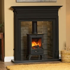 a wood burning stove in a living room next to a brown rug and yellow walls