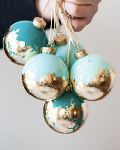 a person holding some ornaments in their hand