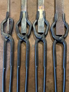 four pairs of scissors sitting on top of a table