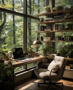 a chair sitting in front of a window next to a desk with a laptop on it