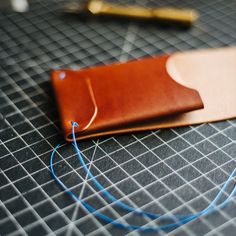 The Archer is a sleek, minimally styled vertical wallet designed to securely hold cards and unfolded cash, while staying slim in the pocket. Designed for US Currency. International customers please be mindful of dimensions below. 3.5 oz Italian Buttero Leather Full-grain leather that gets better with age Stitched by hand with Japanese Vinymo thread Interior card pocket with space for unfolded or halved cash behind Unique closure that keeps the wallet slim and secure Recommend 5-8 cards and 7-10 Stitchless Leather Wallet, Leather Card Wallet Pattern, Leather Women Wallet, Us Currency, The Archer, Leather Card Wallet, Be Mindful, Wallet Pattern, Slim Wallet