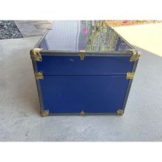 a blue trunk sitting on top of a sidewalk