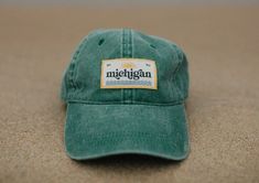 Available in a wide array of perfectly-distressed classic colors (yellow, khaki, forest green, burnt orange, sea blue, wine, gray/blue, light blue), the Michigan Patch Baseball Hat is a must-have for days on the lake, beach, and everything in between. Baseball hats are made of 100% unstructured cotton with a soft crown and low-fitting 6-panel cap, and feature an adjustable strap with a brass buckle. Label designed and sewn locally in Grand Rapids, MI. Adjustable, and one size fits most. Michigan Sticker, Michigan Apparel, Salt Gifts, Birthday Gift Cards, Lake Beach, 6 Panel Cap, Grand Rapids Mi, Green Item, Brass Buckle