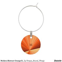 an orange and white circle with the letter m on it is hanging from a metal hoop